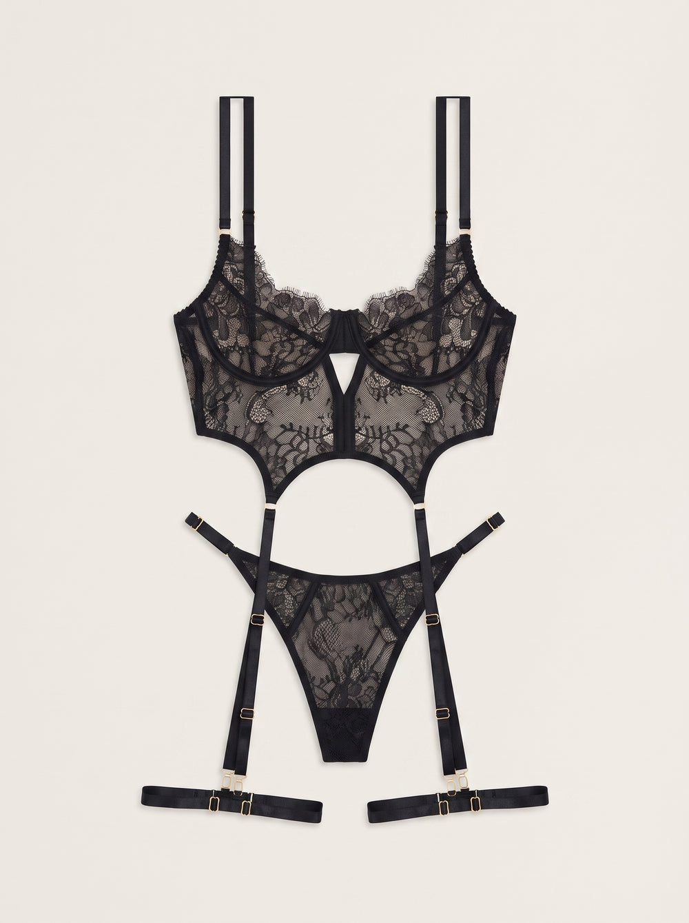Completo di lingerie nero in pizzo con cinturini, reggicalze e schiena con allacciatura a corsetto