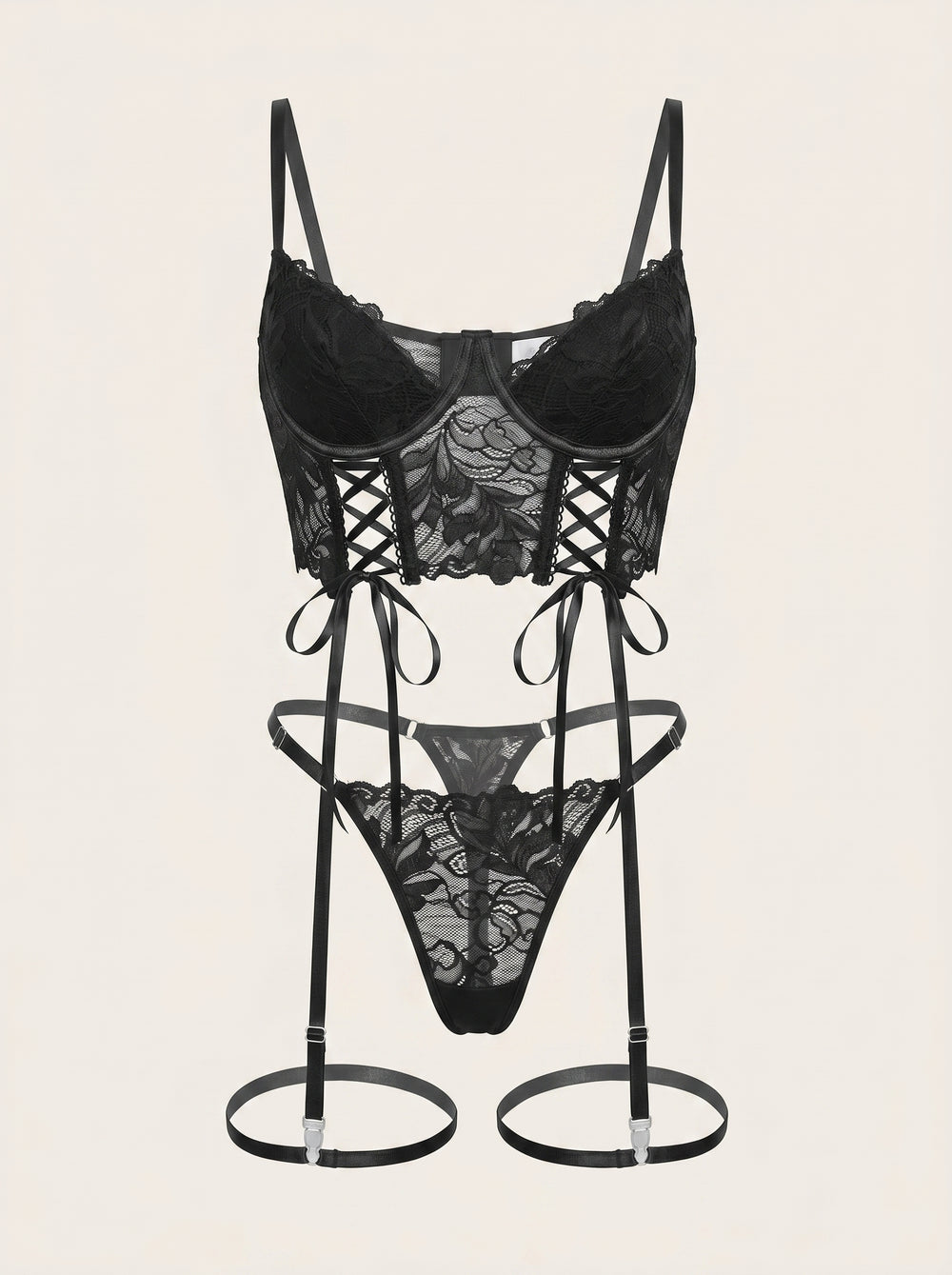 Completo di lingerie nero in pizzo con spalline, reggicalze e dettagli trasparenti